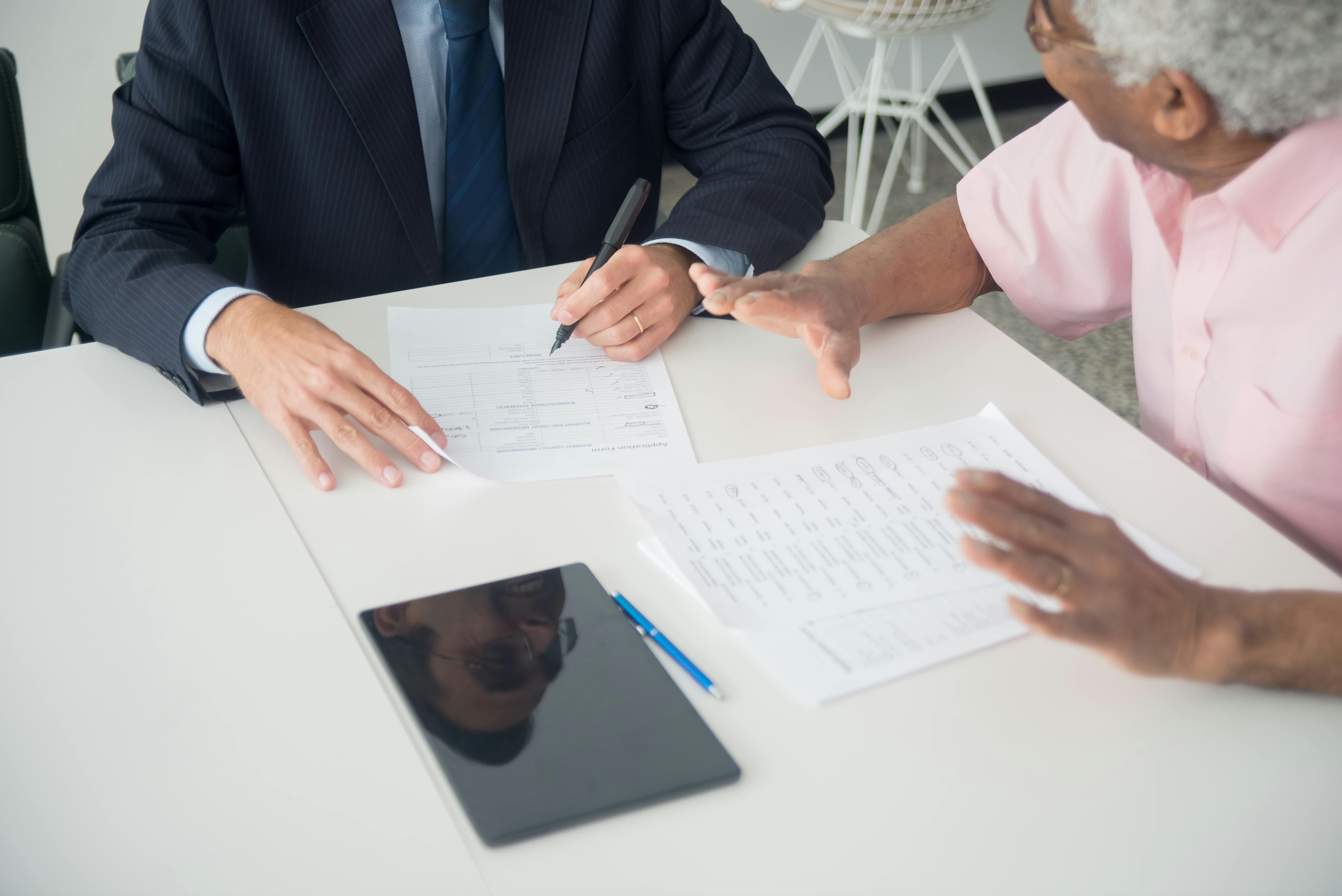 Professional man reviewing car insurance documents on tablet